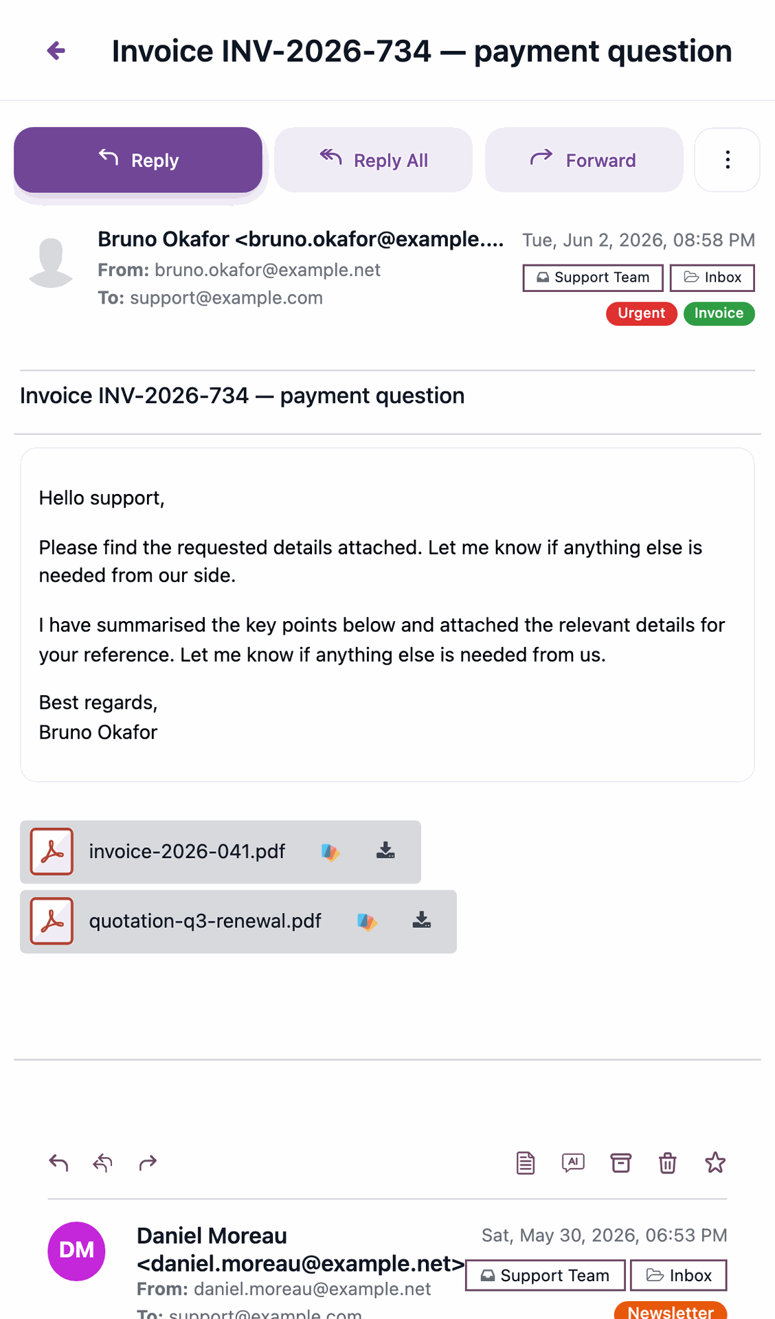 An email open full-screen on a phone showing two PDF attachments listed below the message body